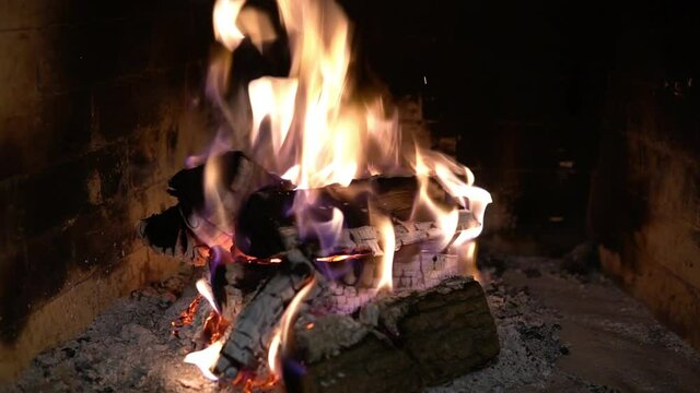Firewood burning in the fireplace. A blazing fire inside the stove. Beautiful burning of palen