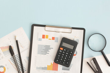 Business graphs, charts, magnifying glass and calculator on table. Financial development, Banking...