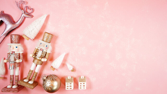 Christmas pink theme holiday background framed border banner styled with reindeers, nutcrackers and ornaments on a textured pink backdrop. Creative composition blog hero header.