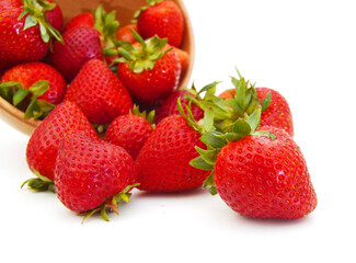 wood bowl with strawberries isolated on white background