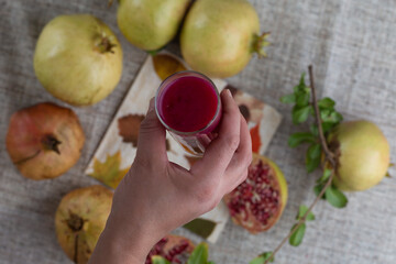top view above of a hand holding pomegranate juice