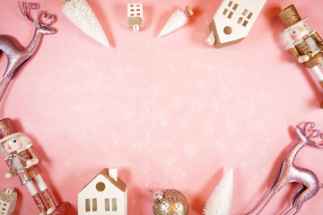 Christmas pink theme holiday framed border background styled with reindeers, nutcrackers, village houses, trees, and ornaments on a textured pink backdrop. Creative composition blog hero header.