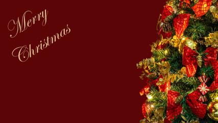 Christmas tree detail with red background Merry Christmas and space for text