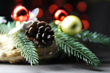 Christmas decoration a sprig of a Christmas tree, a pine cone and Christmas decorations on a...