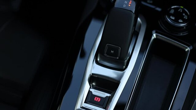 Sport button in a modern car. Electronic parking brake and gear lever.