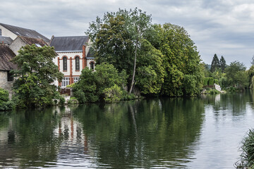 Loing river in Nemours and picturesque houses along the water. Nemours, Seine-et-Marne department,...