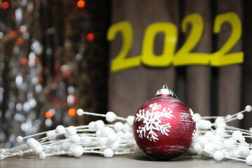christmas decoration red christmas ball with a snowflake on a background of white beads and...