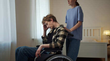 A woman is driving her boyfriend in a wheelchair