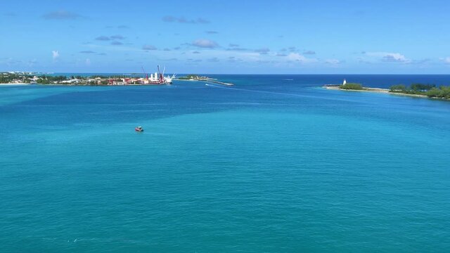 Nassau, Bahamas - October 13, 2021: An aerial view of the cruise ship harbor looking out at the turquoise blue ocean in Nassau, Bahamas from a cruise ship that is sailing away.