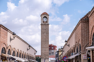 Old clock tower with blue and clouds sky in Adana, Turkey.