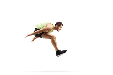 Full length profile shot of a male athlete performing a long jump - obrazy, fototapety, plakaty