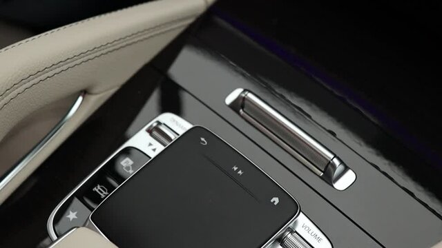 Touch panel of multimedia system control in a modern premium car. Navigation joystick