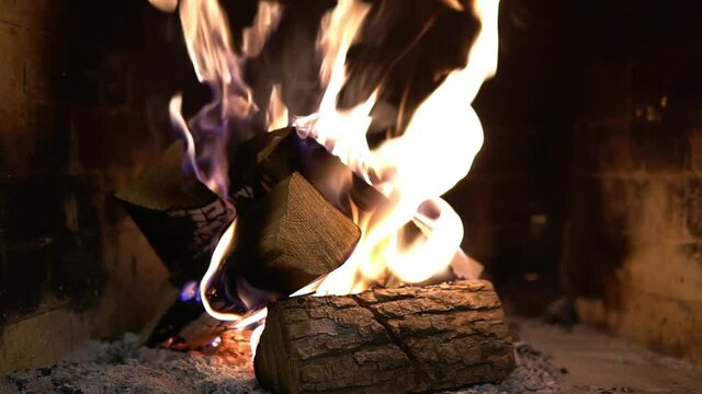 Firewood burning in the fireplace. A blazing fire inside the stove. Beautiful burning of palen