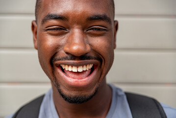 Portrait of afro young man smiling outdoors