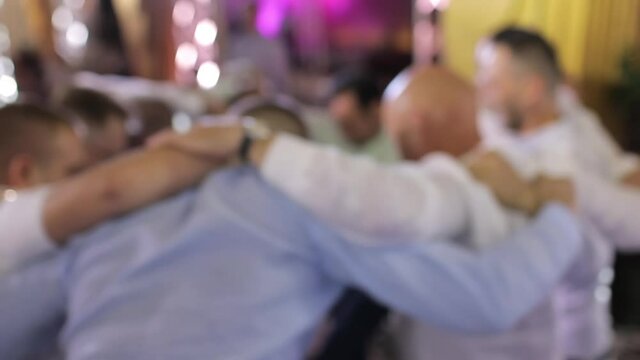 Blurred persons dance in a circle, Jewish tradition