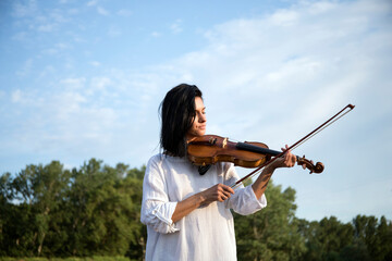 Violinist holding in your hands the violin. Background. Violin. Music concept. 
