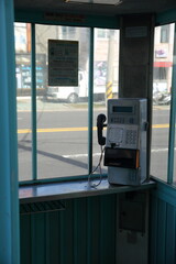 empty phone booth on the corner of the street in jeju island