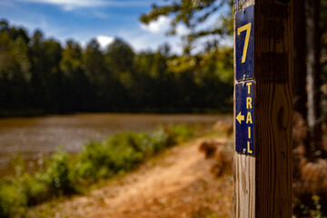 trail head Hiking trail marker near lake hiker's background © Jon