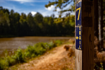 trail head Hiking trail marker near lake hiker's background