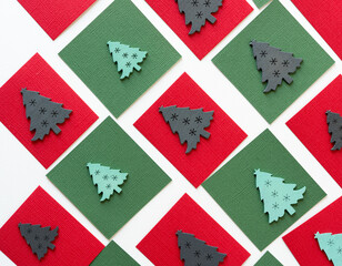 wooden christmas tree shapes or silhouettes arranged on paper squares