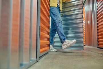 Legs of man walking out of garage door