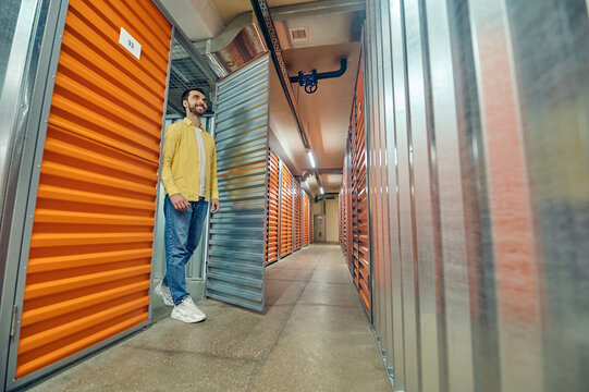 Smiling Man Walking Out Of Garage Box Door