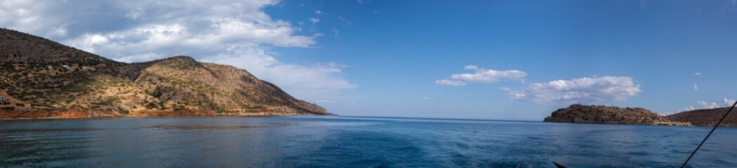 Fototapeta na wymiar panoramic view of the village of Plaka in Crete from the sea, horizontal