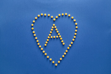 Composition with vitamin A pills on color background