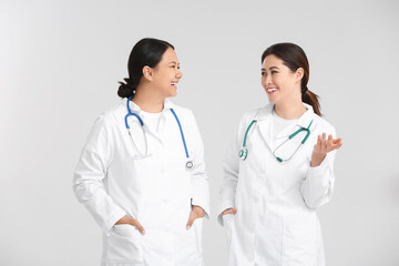 Fototapeta premium Portrait of female Asian doctors on light background