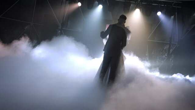 the newlyweds dance in the smoke