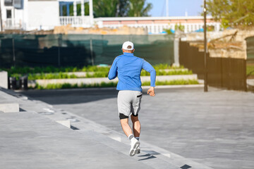 Fototapeta premium Sporty mature man running on stairs outdoors