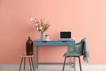 Modern workplace and chair with plaid near color wall