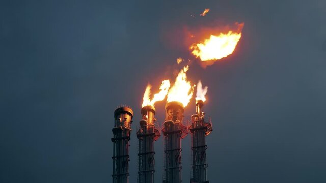 Fire of burning gas is getting released by flare stacks