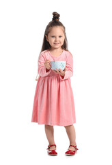 Adorable little girl with cup of hot cocoa on white background
