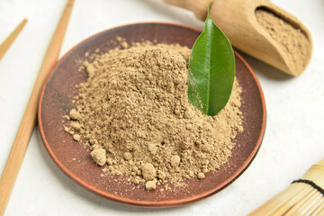 Plate with hojicha powder on white background, closeup