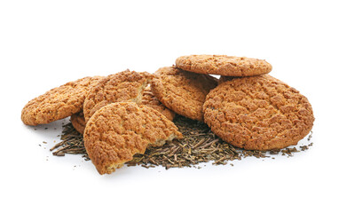 Tasty hojicha cookies and dry leaves on white background