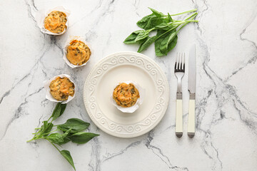 Composition with tasty spinach muffins on light background