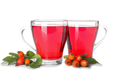 Glass cups of tasty rose hip tea and berries on white background