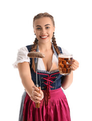Young Octoberfest waitress with beer and sausage on white background
