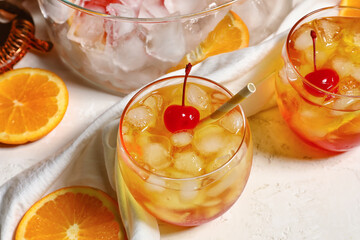 Glasses of cold Tequila Sunrise cocktail on white background