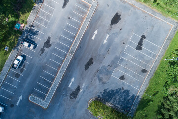 Aerial view top down of car parking lot with white line of traffic sign on the street. Above view...
