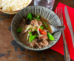 Traditional dish of Thai cuisine is beef with basil, cooked in meat broth. Served with rice