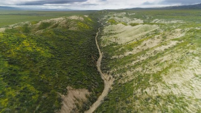 Cinematic close up view on trail in the middle of San Andreas fault. Geographical place where two tectonic plates Pacific and North-American are moving in different directions forcing earthquakes USA