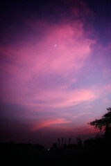 Beautiful red sky with round moon during sunset
