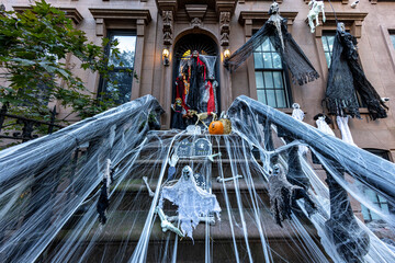 A townhouse with Halloween decorations on a New York City street.