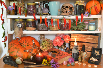 Vintage kitchen still life with witchcraft ritual obects, mystic books of spells, bottle of potion,...