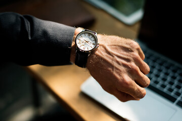 Businessman looking at his watch closeup