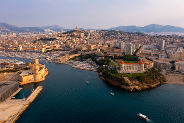 Fototapeta na wymiar Aerial panoramic view of seaside areas of French city of Marseille on Mediterranean coast overlooking ancient Fort Saint-Jean 
