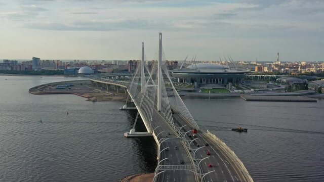 Aerial around view of cable-stayed bridge and new stadium in St.Petersburg during sunset, 4k