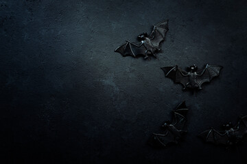 Happy Halloween black background with bats and spiders with copy space